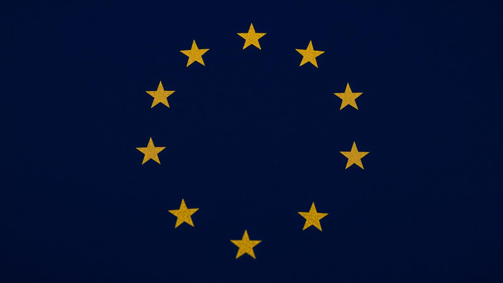 Gold EU stars arranged in a circle on a deep blue background